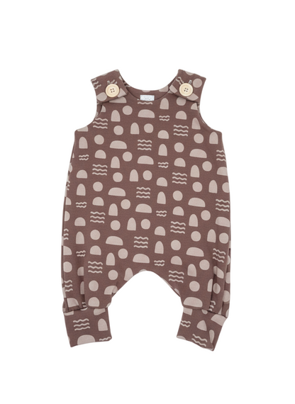Mocha baby romper with button closures on a white background. Geometric shapes and wavy lines in cream. Designed with room to grow for longer wear