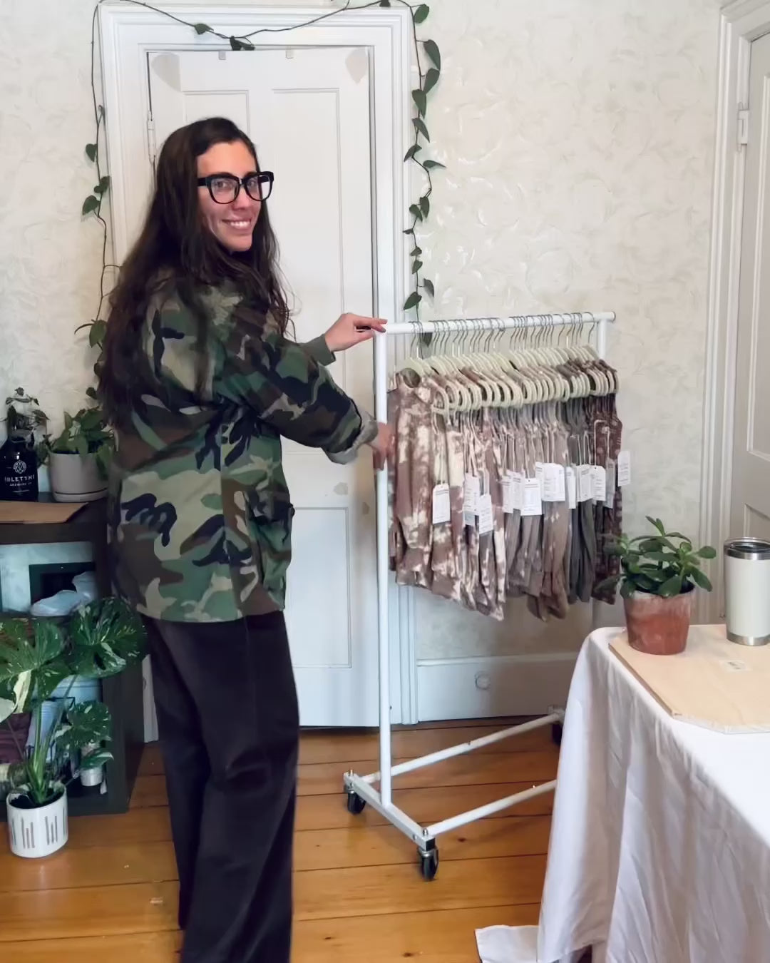room to grow rompers hanging on clothing rack rolling into frame. one at a time each color romper is held in frame. Mauve Tie Dye, Grey Cactus, Willow Green, and then Mocha Shapes. 