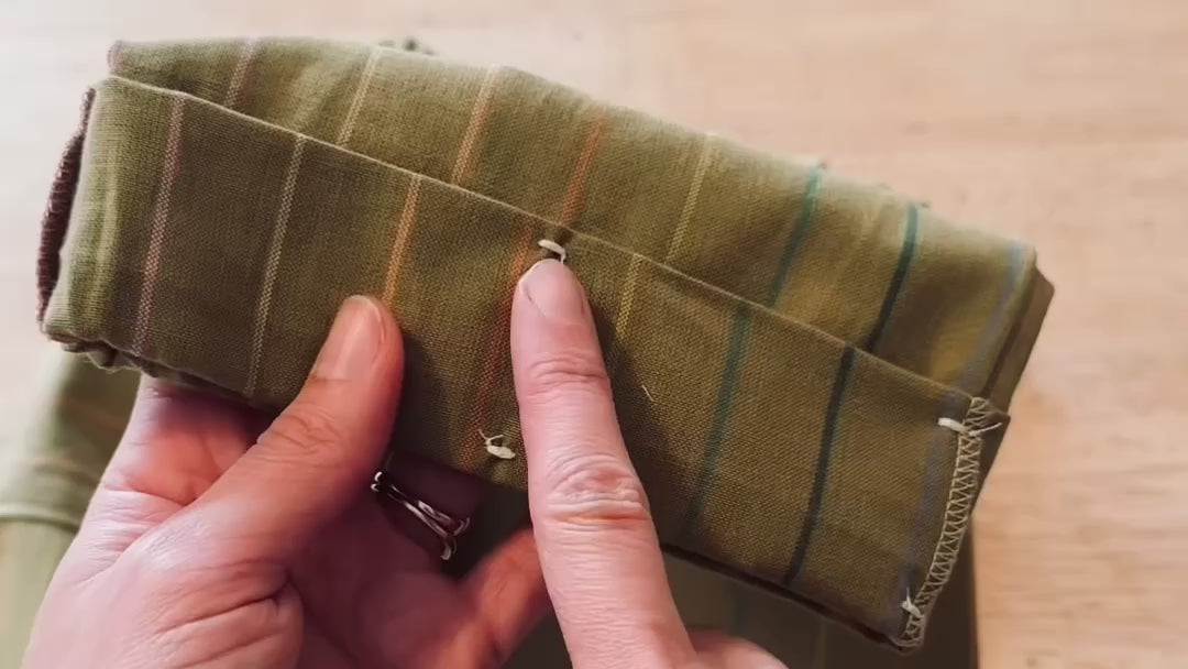 Load video: video of moss green size adjustable pants demonstrating where you snip at the cuff for extra length and demonstrating how the waistband slides like a bra strap to tighten and loosen