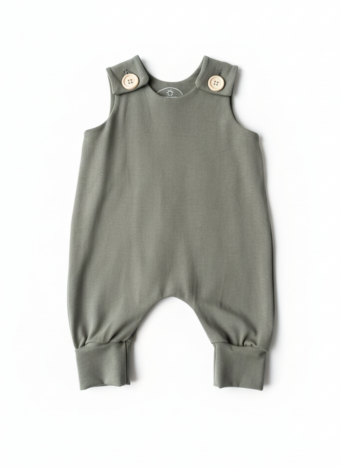 Willow Green baby romper with button closures on a white background. Designed with room to grow for longer wear