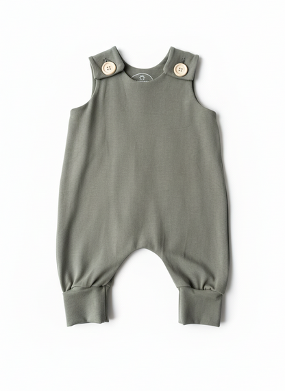 Willow Green baby romper with button closures on a white background. Designed with room to grow for longer wear